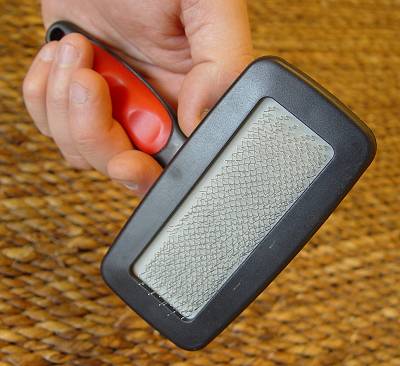 special curved slicker brush with an unbreakable handle.